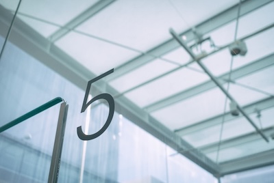 5 on glass wall