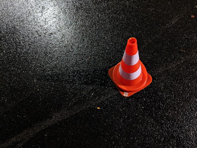 Orange cone on asphalt