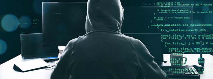 hacker in a hooded sweatshirt with lines of code projected