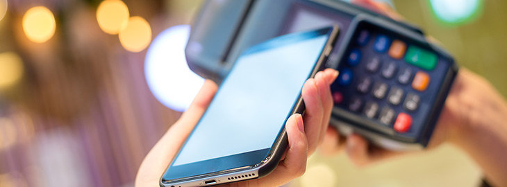 Woman pay with cellphone by NFC technology