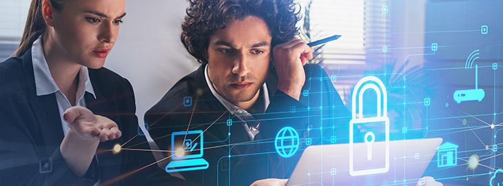 Two thoughtful business people with laptop, desktop at office interior, blue glowing information protection icons. Padlock and business data symbols. Concept of cyber security and data storage