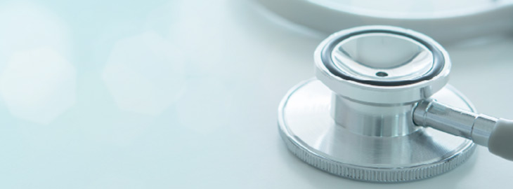 closeup of stethoscope on light blue background