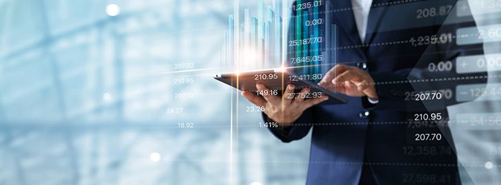 Businessman using tablet analyzing sales data and economic growth graph chart.