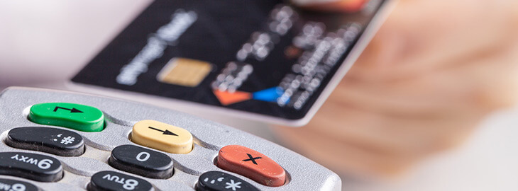 female inserting credit card into card reader