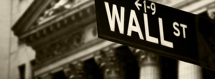 Wall St. street sign with bank building in background
