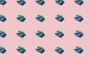copies of blue cameras on light pink background