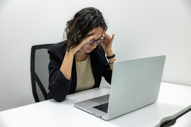 concerned business woman at desk with computer