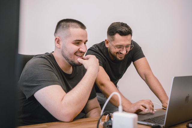 two professionals working on laptop