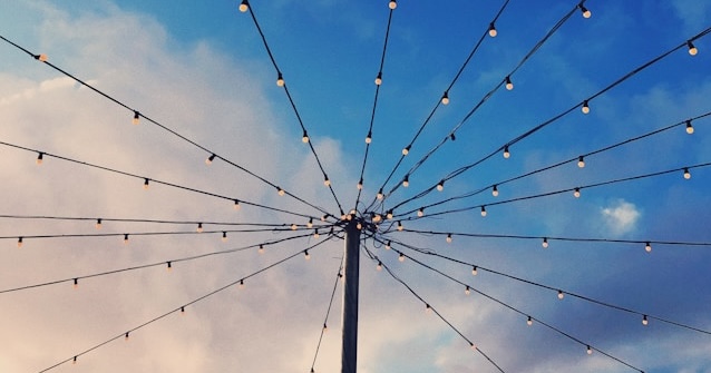 lights on pole with clouds and sky in background
