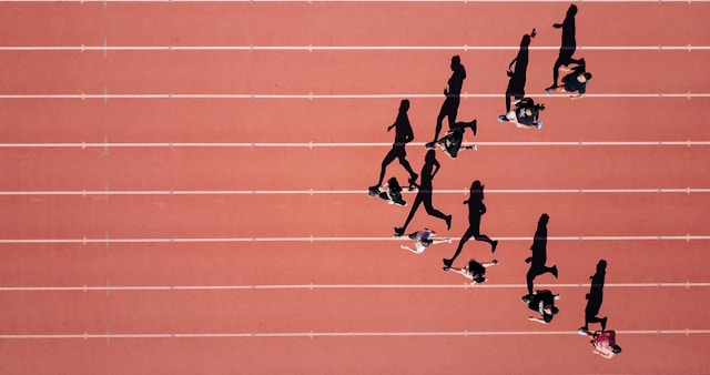 runners on red track with white lines